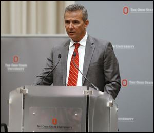 Ohio State football coach Urban Meyer makes a statement during a news conference in Columbus, Ohio, Wednesday.