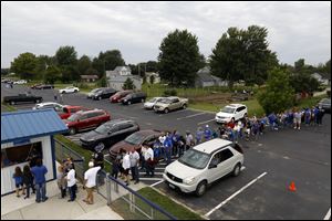 Fans line up to buy tickets for Stryker High School's first game since 1931. The team began with junior varsity two years ago and made its varsity debut Friday against Holgate with 18 members. 
