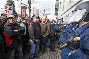 Demonstrators protest against right-to-work legislation in Michigan in 2012, before Gov. Rick Snyder signed right-to-work into law. Many of Ohio's neighboring states have adopted right-to-work, which supporters claim can help lure jobs from states with forced union membership.