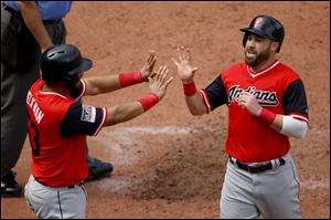 Cleveland Indians' Melky Cabrera, left, and Jason Kipnis celebrate after scoring on a two-run single by Francisco Lindor during the sixth inning.