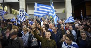 Demonstrators wave Greek national flags during a demonstration in February, 2018.