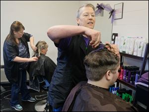 Connie Ludwig, front, and Charlene Hixon cut the hair of Alex Ogle and Betsy Shaffer, respectively, at Sensational Styles in Coshocton.