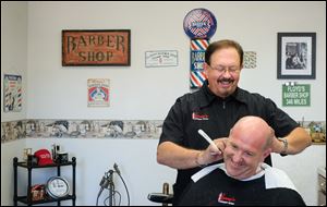 Lenny Fowler, owner of Lenny's Barber Shop, cuts Dirk Sundheimer's hair in Coshocton.