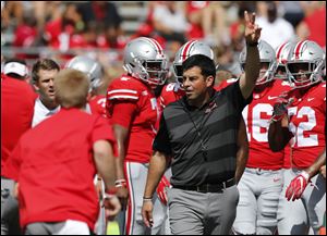 Ohio State acting head coach Ryan Day watches warm-ups before the start of Saturday's game against Oregon State. 