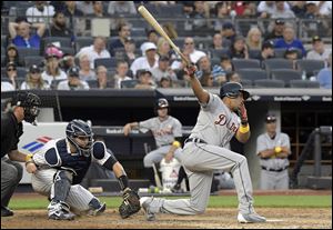 Detroit Tigers pinch hitter Jeimer Candelario, right, strikes out as New York Yankees catcher Gary Sanchez, second from left, looks on,