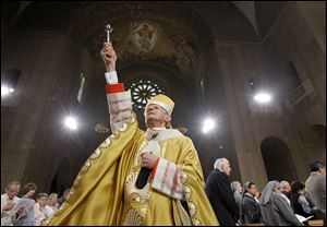 Cardinal Donald Wuerl, Archbishop of Washington, sprinkles Holy Water during Easter Mass at the Basilica of the National Shrine of the Immaculate Conception in Washington in 2011. Last month, a Pennsylvania grand jury accused Cardinal Wuerl of helping to protect abusive priests when he was Pittsburgh's bishop. 