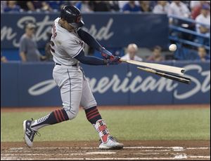 Cleveland Indians' Francisco Lindor hits a broken-bat single to drive in two runs against the Toronto Blue Jays.