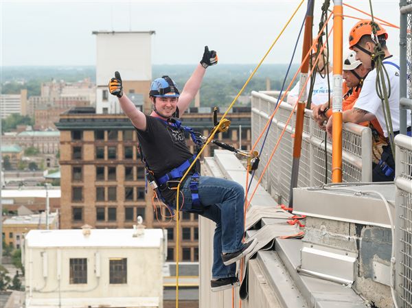 Blade reporter rappels down Toledo building for charity