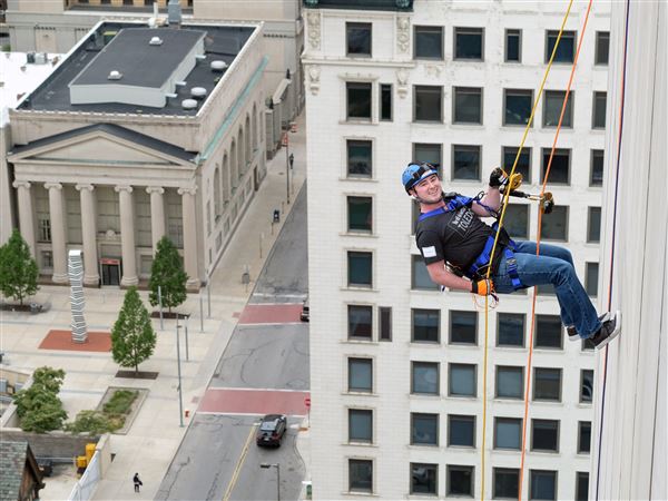 Reaching high: Blade reporter rappels down building for charity