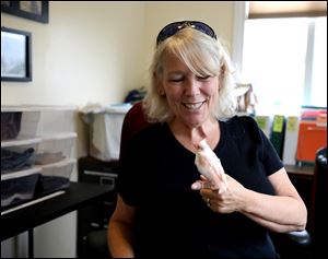 Laura Zitzelberger, operations director of Nature's Nursery, holds a fledgling albino cardinal at Nature's Nursery in Whitehouse.