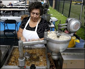 Helen Matthews, of Toledo, prepares loukoumathes during the Toledo Greek-American Festival.