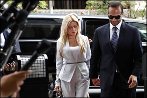 Former Donald Trump presidential campaign foreign policy adviser George Papadopoulos, right, who pleaded guilty to one count of making false statements to the FBI during the agency's Russia probe, holds hands with his wife Simona Mangiante, as they arrive at federal court for sentencing Friday.
