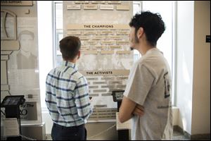 Connor Kelley, left, and Javier Gomez view an exhibit at the Civil Rights Museum Greensboro, N.C.