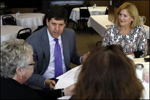 Democratic nominee for Attorney General Steve Dettelbach, center left, discusses human trafficking during a roundtable at Michael's Bar and Grill in Toledo in August.