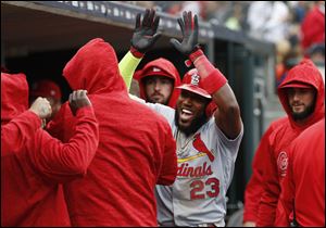 St. Louis Cardinals' Marcell Ozuna reacts after scoring in the seventh inning against the Detroit Tigers.
