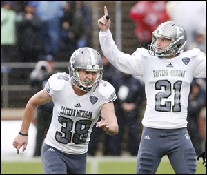 Eastern Michigan kicker Chad Ryland, left, reacts after his field goal as time ran out lifted the Eagles to a 20-19 victory over Purdue on Saturday