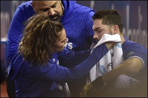 Toronto Blue Jays trainer Nikki Huffman treats Blue Jays right fielder Randal Grichuk after he collided with a security guard in foul territory during Sunday's game against the Cleveland Indians.
