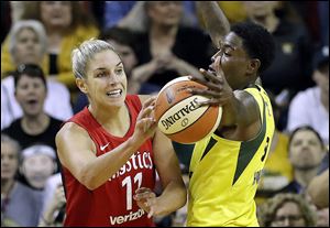 Seattle’s Natasha Howard, right, deflects a pass by Washington’s Elena Delle Donne in the second half of Game 2 of the WNBA Finals. Howard finished with eight points and a game-high 13 rebounds in the Storm’s win.