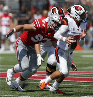 Ohio State defensive lineman Nick Bosa, left, sacks Oregon State quarterback Conor Blount during the first half on Sept. 1 in Columbus.