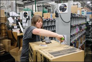 Angela Thorp processes multi orders at the Best Buy Distribution Center  Thursday in Findlay.