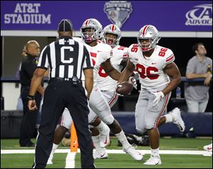 Ohio State defensive tackle Dre'Mont Jones (86) scores a touchdown on an interception during the second half of Saturday's game against TCU.