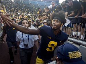 Michigan wide receiver Donovan Peoples-Jones receives high fives from fans as he exits Michigan Stadium following Saturday's win over SMU. Peoples-Jones caught 3 touchdown passes from quarterback Shea Patterson.