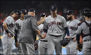 Cleveland Indians starting pitcher Corey Kluber, center, is pulled from the game during the fifth inning.