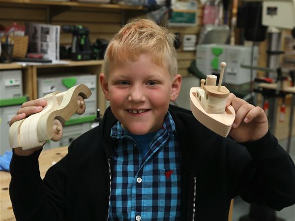 Children construct Christmas cheer at woodworking event