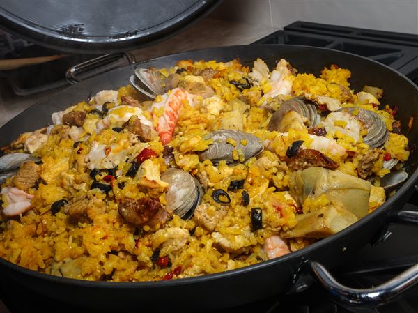 Tim Valko and Jim Moore, leaders of the Appetite for the Arts series with the Arts Commission, prepare paella in the WS Design Kitchen & Bath Studio test kitchen.