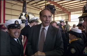 Senior Chief Petty Officer Kenneth Cox, left, enjoys one of Bob Dole's frequent quips during a gathering of the Republican faithful at Custer Airport in Monroe, Mich.