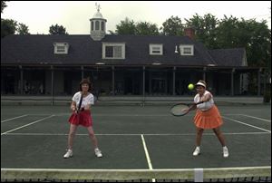 Phyllis Bernstein and Nancy Winsor play a doubles game at Toledo Tennis Club.