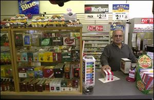 `I'll tell you what: They'll never ban it here. I won't enforce it,' says Doug Kanag owner of the Smoke Shack near the intersection of Reynolds Road and Dorr Street. Mr. Kanag is against a proposed ban on smoking in all public places in Lucas County.