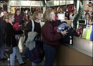 Margie Kayser of Toledo joins dozens in line at the Old Navy store that opened recently in Springfield Township.