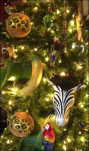 The den features a tree decorated with a safari theme, including zebra and animal-print ornaments.