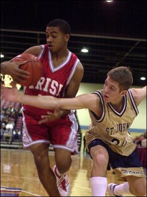 Central Catholic's Manga Shuman steals the ball from Sam Anderson of St. John's. Shuman led the Irish with 13 points. Central, which had its only lead in the game at 1-0 on Shuman's free throw 42 seconds into the contest, trailed 25-16 at halftime.