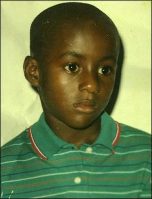 Francis Nmah, 9, whose student visa to join his family in this country was denied, remains in Liberia. `We don't feel right - our son's there, and our families are there. It's not easy,' says his father, Gabriel, who came here in 1998 with his wife, Margaret.