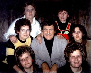 <xh>Family members surround Bob Harmon, who has made Seneca County smile with his stories. From left are, in bottom row, twin daughters Andy and Sandy Harmon; in middle row, wife Arden, Bob, and daughter Cara Kelley; and in top row, daughters Shar Harmon and Erin Blake.