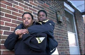`I'm happy about the ruling, but that's just one step on the stair,' says Vicki Robinson, with son Harold DeLynn Harris.