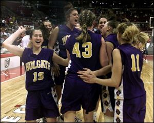 Alissa Gill celebrates with her teammates after Holgate defeated Worthington Christian 70-65 in a Division IV state semifinal. Gill sank a 3-pointer to send the game into overtime.