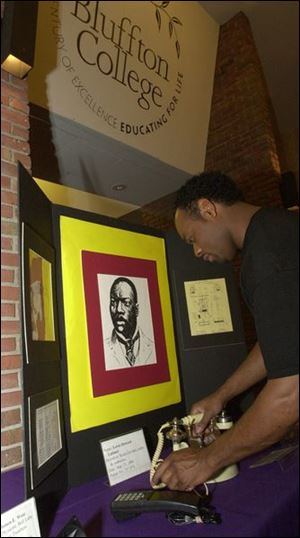 James Ince, who travels with the exhibit, sets up the display of Granville T. Woods, who invented a telephone transmitter in December of 1884.