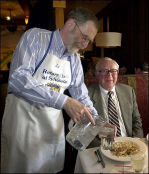 TOP IT OFF: Sylvania Schools superintendent Les Schultz, serves Greg Alexander.