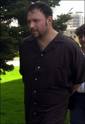 Anthony E. Baldwin is escorted to U.S. District Court.