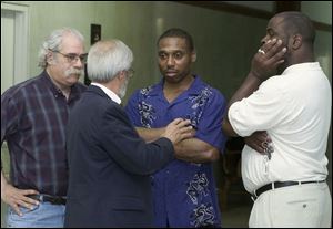 Danny Brown, right, talks with attorneys Jeff Gamso, left, and Jon Richardson outside the Lucas County common pleas courtroom where the case against him was dismissed.