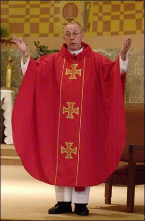 The Rev. Joseph Kappes turns to the congregation at Gesu Church during Mass and says, `The Lord be with you.' The guidelines call for the people to respond, `And with your spirit.'