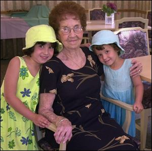 HAPPY BIRTHDAY!: Anisa, 5, left, and JulieAnne Warr, 4, snuggle up to their great-grandmother, Adaline Manley Richards at Ms. Richards' 90th birthday party.