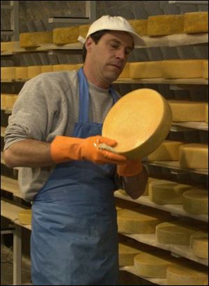 John Hoyt tends raclette cheese daily at Leelanau Cheese. 