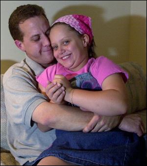 Steve Bruno and his daughter, Brooke, 8, share a hug.