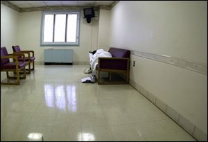 A woman who has been evaluated at Rescue Mental Health Services rests in an interview room at the facility on Collingwood Boulevard.
