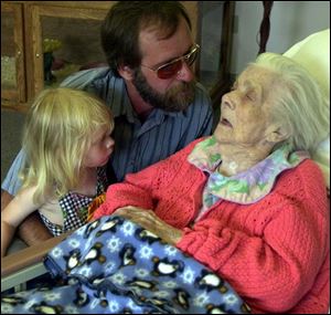 Jay Neusbaum pays a visit to his grandmother at her nursing home with his own granddaughter, Desiree Woodcox.