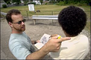 Local activist Rick Van Landingham makes a point, above, while talking to Lourdes Santiago, the city's acting director of neighborhoods, as they look over some property near the intersection of Edison and Bassett streets.